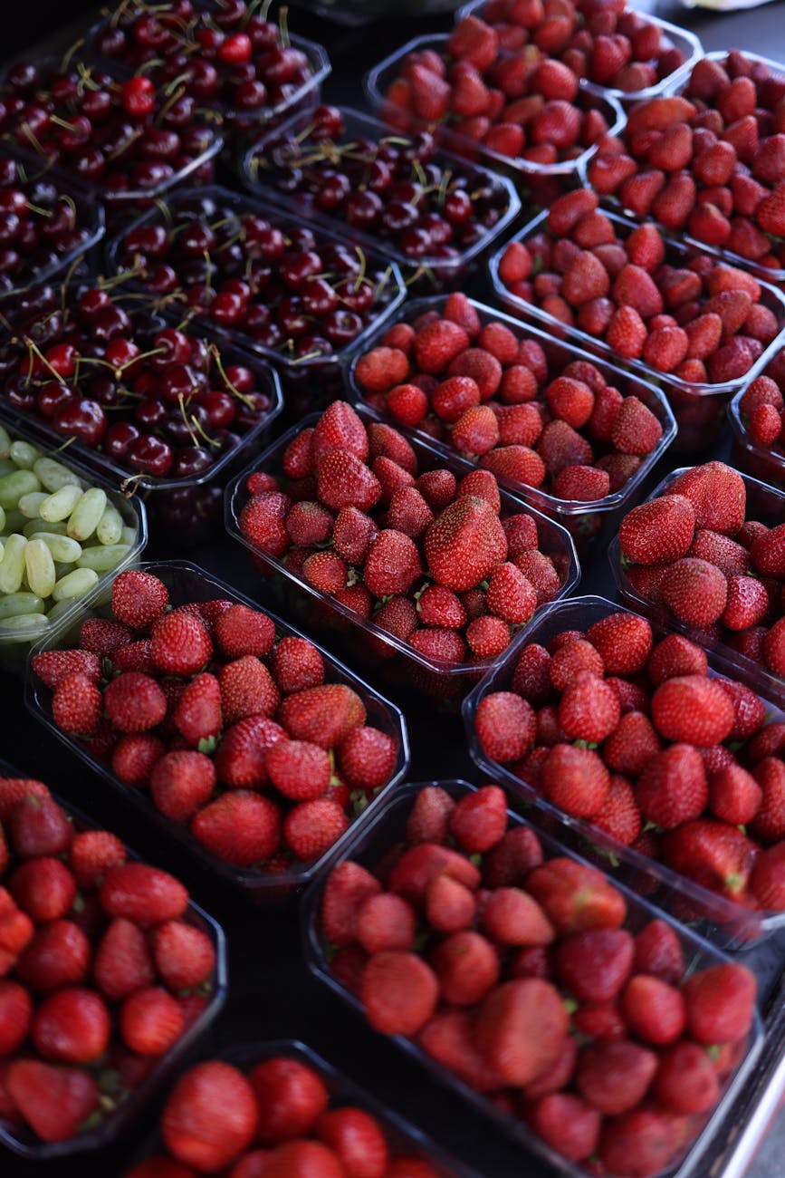 packs of fresh strawberries and cherries